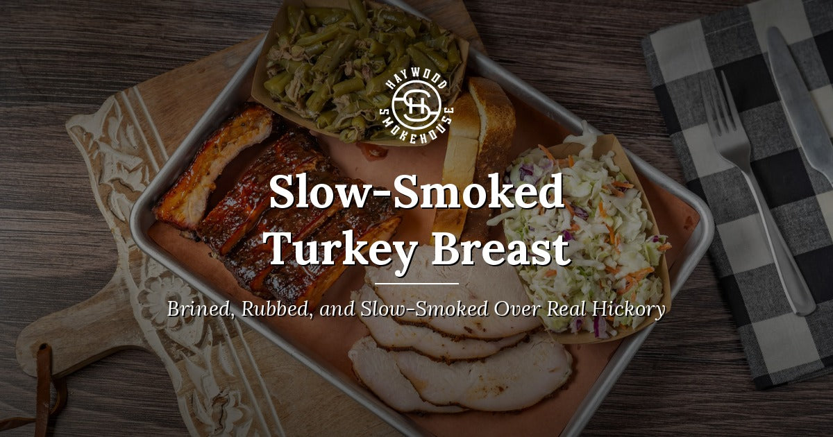 Haywood Smokehouse slow-smoked turkey breast, sliced on a platter with ribs, green beans, coleslaw, and Texas toast.